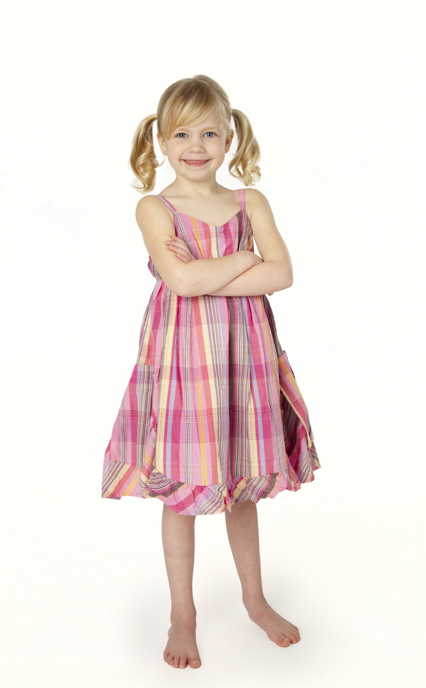 Little girl smiling with arms folded